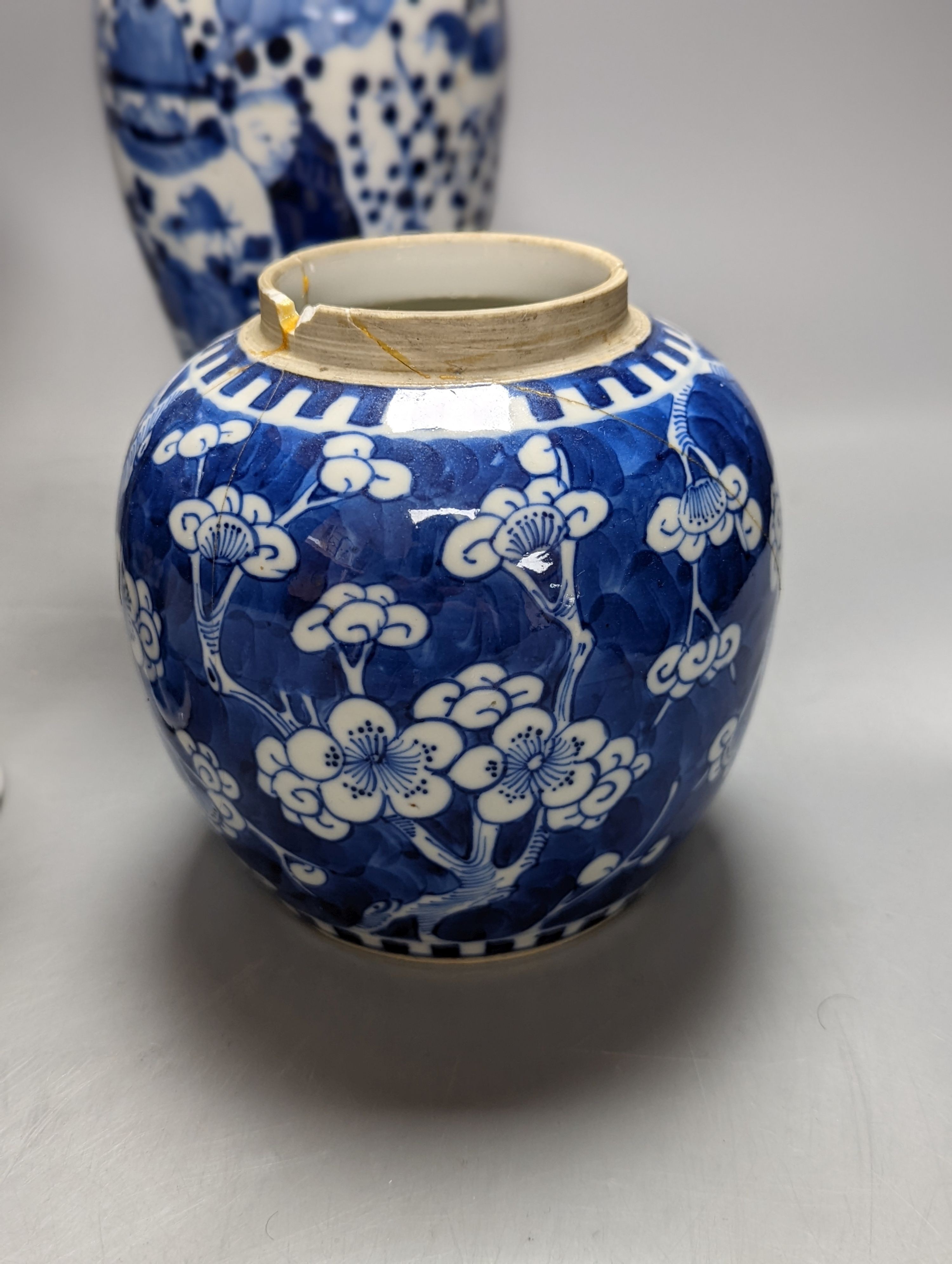 A pair of 19th century Chinese blue and white vases, a prunus vase and cover and a similar jar (4), pair of vases 24 cms high.